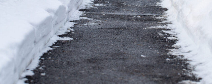 Winter sidewalk cleared of with snow.